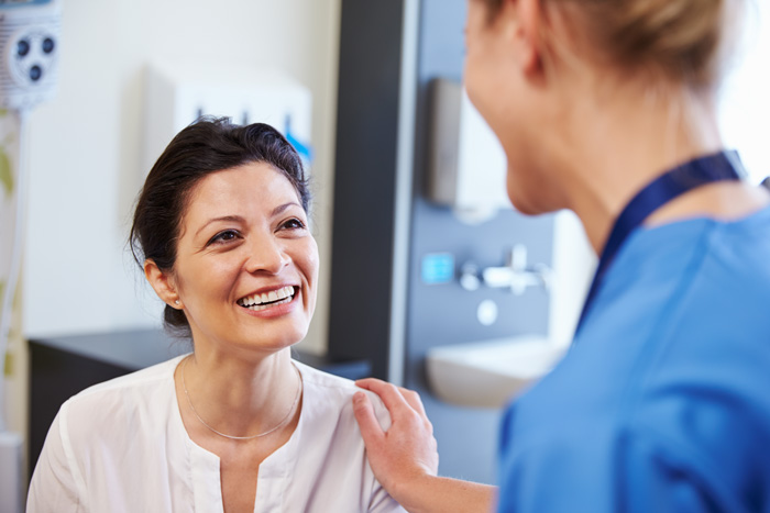 nurse comforting female patient